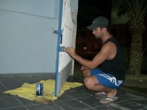 Omar paints the gate