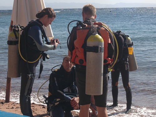 Divers waiting on the beach